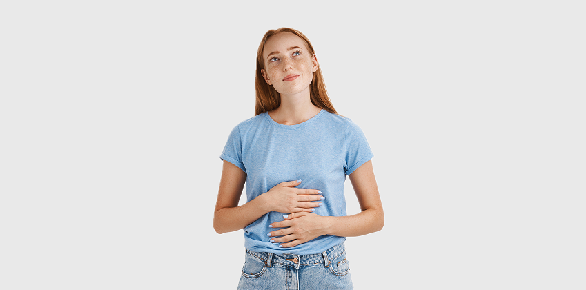 a girl in a blue shirt with a stomach ache