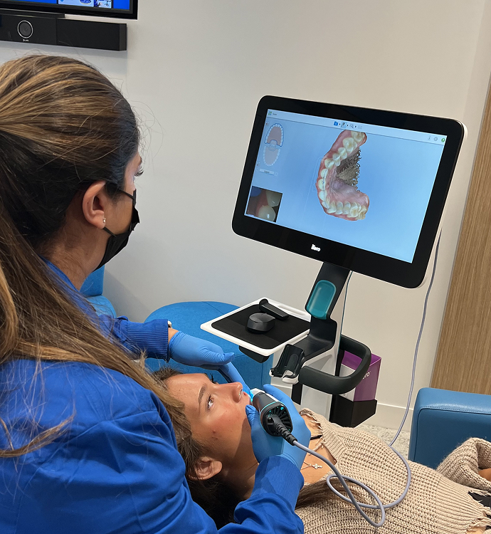 A nurse scanning teeth with an iTero machine
